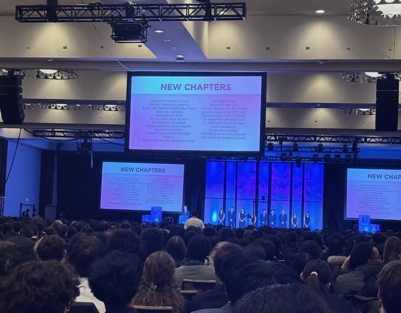 The Provincials main stage showing a New Chapters slide that lists the school